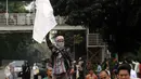 Massa aksi damai mengibarkan bendera di sekitar Bundaran Patung Arjuna Wijaya, Jakarta, Jumat (4/11). Massa berkumpul untuk melakukan aksi di depan Istana Negara menuntut penegakan hukum kasus dugaan penistaan agama. (Liputan6.com/Helmi Fithriansyah)