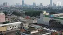 Lansekap pemukiman penduduk berlatar gedung bertingkat terlihat dari Tanah Abang, Jakarta, Selasa (21/5). Laporan Oxford Economics berjudul Global Cities 2018 menyebut Jakarta akan jadi kota dengan jumlah penduduk terbesar di dunia pada 2035, yakni 38 juta jiwa. (Liputan6.com/Immanuel Antonius)