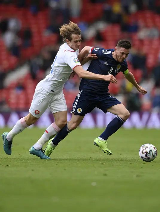 Gelandang Republik Ceko, Alex Kral berusaha merebut bola dari pemain Skotlandia, Andrew Robertson pada pertandingan grup D Euro 2020 di stadion Hampden Park, Glasgow, Senin (14/6/2021). Ceko menang atas Skotlandia dengan skor 2-0. (Stu Forster, Pool via AP)