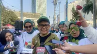 Wakil Ketua DPR Muhaimin Iskandar alias Cak Imin ikut menyosialisasi UU Nomor 4 tahun 2024 tentang Kesejahteraan Ibu dan Anak (KIA) di kawasan CFD Jakarta, Minggu (21/7/2024). (Liputan6.com/ Muhammad Radityo Priyasmoro)