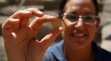 Seorang arkeolog Israel menunjukkan koin emas yang ditemukan di sebuah situs arkeologi di Kota Yavne, Israel tengah, pada 25 Agustus 2020. Harta karun langka berupa 425 koin emas murni berumur sekitar 1.100 tahun ditemukan di Israel tengah. (Xinhua/Gil Cohen Magen)