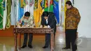 Mendagri, Tjahjo Kumolo (kiri) bersama Ketua KPU Husni Kamil Manik  (tengah) menandatangani Data Agregat Kependudukan per-Kecamatan (DAK2) dari kemendagri ke KPU di Kantor Kemendagri, Jakarta, Jumat (17/4/2015). (Liputan6.com/Herman Zakharia)