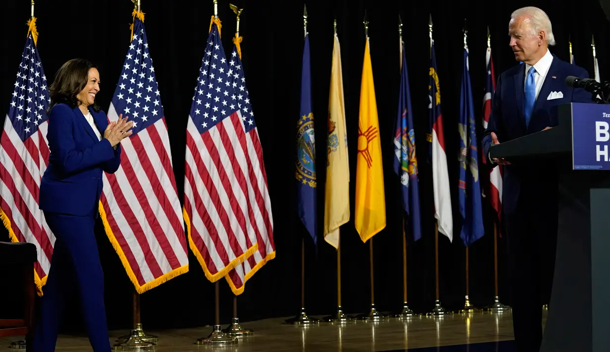 Calon Presiden Partai Demokrat, Joe Biden memperkenalkan pasangannya, Kamala Harris untuk berbicara selama acara kampanye di Alexis Dupont High School di Wilmington, Rabu (12/8/2020). Keduanya tampil perdana di depan publik sebagai pasangan capres-cawapres. (AP Photo/Carolyn Kaster)