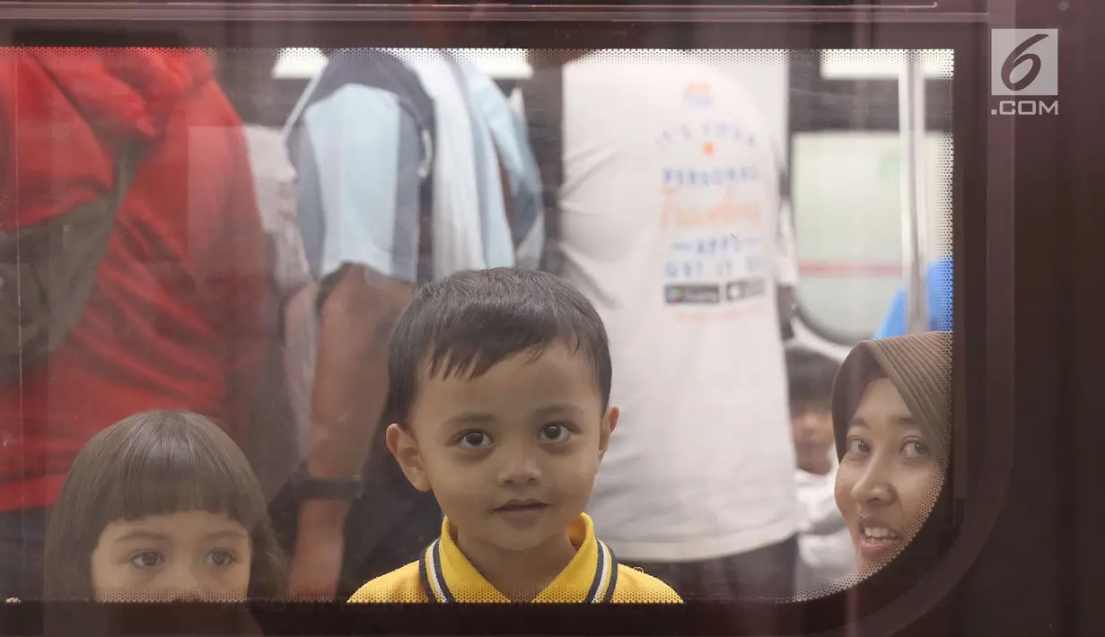 Anak-anak melihat ke luar jendela saat mencoba LRT di kawasan Rawamangun, Jakarta, Rabu (12/9). Perjalanan dari Velodrome Rawamangun hingga Stasiun Boulevard Utara Kelapa Gading ditempuh selama 20 menit. (Liputan6/Immanuel Antonius)