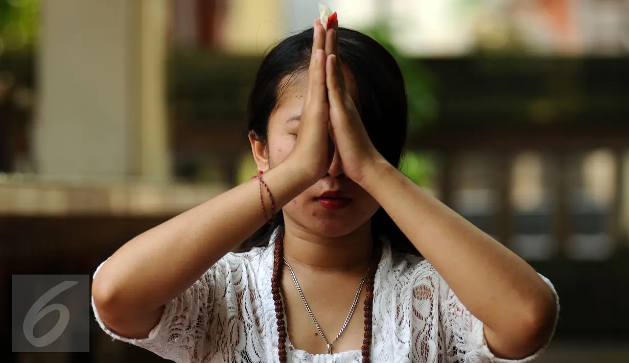 Umat Hindu melakukan sembahyang saat perayaan Nyepi di Pura Aditya Jaya, Rawamangun, Jakarta, Selasa (28/3). Nyepi dirayakan dengan melakukan kegiatan keagamaan di pura. (Liputan6.com/Helmi Fithriansyah)