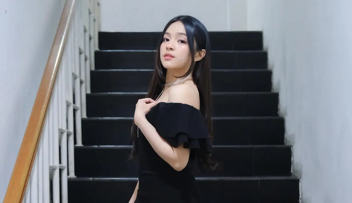 Eca Aura tampil cantik elegan pakai off-the-shoulder dress hitam yang memiliki detail slit di bagian belakangnya. [Foto: Instagram/elsaajapasal]