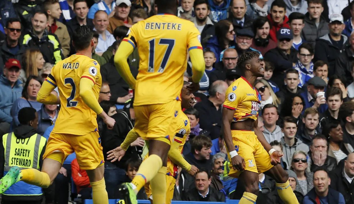 Para pemain Crystal Palace merayakan gol yang dicetak Wilfried Zaha ke gawang Chelsea. Dua gol kemenangan Palace dibukukan oleh Zaha dan juga Christian Benteke pada babak pertama. (AFP/Ian Kington)