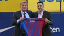 Presiden Klub Barcelona, Joan Laporta berhasil meyakinkan Xavi Hernandez untuk menangani Barcelona setelah kesuksesannya membesut Al-Sadd di Liga Qatar dengan raihan deretan trofi domestik. (AFP/Lluis Gene)