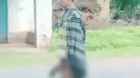 Tangkapan layar video sadis yang menunjukkan seorang pria menenteng bagian tubuh manusia dan tertulis lokasi Jalan Trans Palu - Napu, Poso. Tim Cyber Polda Sulteng dilibatkan menelusuri informasi tersebut.
