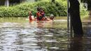 Petugas mengevakuasi warga yang terjebak banjir di kawasan Kemang, Jakarta, Sabtu (20/2/2021). Curah hujan yang tinggi menyebabkan kawasan tersebut terendam banjir setinggi orang dewasa. (Liputan6.com/Johan Tallo)