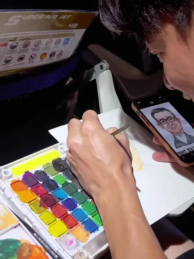 Andre melukis karikatur Anies Baswedan di Pesawat