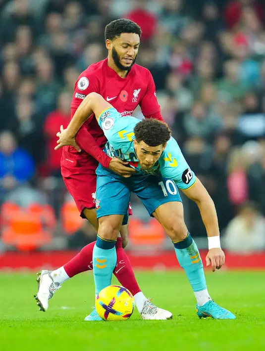 Pemain Southampton Che Adams (kanan) berebut bola dengan pemain Liverpool Joe Gomez pada pertandingan sepak bola Liga Inggris di Stadion Anfield, Liverpool, Inggris, 12 November 2022. Liverpool mengalahkan Southampton dengan skor 3-1. (AP Photo/Jon Super)