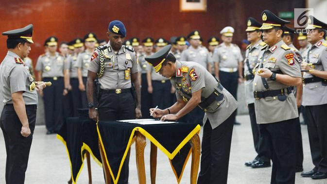 Kapolri Jenderal Tito Karnavian (kiri) menyaksikan Kabareskrim Irjen Pol Idham Azis menandatangani dokumen saat sertijab di Jakarta, Kamis (24/1). Tito memimpin langsung sertijab 17 perwira tinggi Polri. (Merdeka.com/Imam Buhori)
