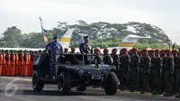 Marsekal TNI Hadi Tjahjanto memeriksa pasukan dengan menaiki mobil komando saat upacara peringatan Hari Ulang Tahun (HUT) ke-71 di Taxi Way Skuadron Udara Bandara Halim Perdanakusuma, Jakarta, Minggu (9/4). (Liputan6.com/Faizal Fanani)