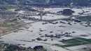 Pemandangan dari udara menunjukkan area banjir akibat hujan deras di Takeo, Prefektur Saga, barat daya Jepang, Minggu (15/8/2021). Hujan deras memicu tanah longsor dan  banjir di sejumlah wilayah Jepang menyebabkan tiga orang  tewas dan memaksa evakuasi puluhan warga. (Kyodo News via AP)