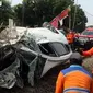 Petugas mengevakuasi mobil Honda Mobilio yang tertabrak KRL Commuterline KA 1077 (Bogor-Jakarta Kota) di kawasan Rawageni, Ratu Jaya, Cipayung, Depok, Jawa Barat, Rabu (20/4/2022). Pengemudi kendaraan dibawa ke rumah sakit. (merdeka.com/Arie Basuki)