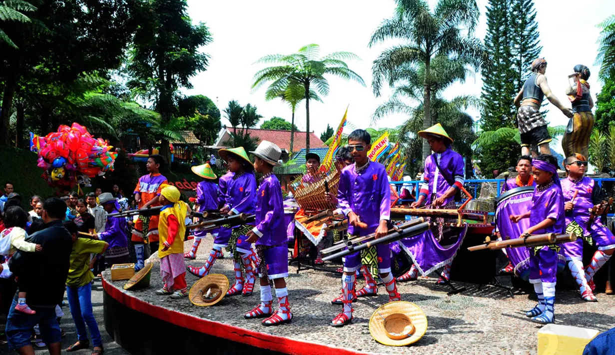 Sejumlah anak memainkan musik untuk menghibur wisatawan yang berkunjung di objek wisata Baturraden, Purbalingga, Jawa Tengah, (31/7/2014). (Liputan6.com/Andrian M Tunay)