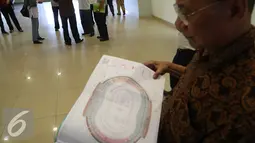 Seorang tenaga ahli konstruksi mengamati denah Stadion Gedebage, Bandung, Rabu (10/6/2015). Penyidik Dirtipidkor Polri dan sejumlah tenaga ahli mengecek fisik stadion dalam kasus korupsi pembangunan Stadion Gedebage (Liputan6.com/Awan Harinto)