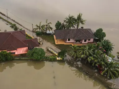 Foto udara menunjukkan dua rumah yang dikelilingi oleh banjir setelah hujan lebat di Kota Bharu, negara bagian Kelantan, Malaysia pada tanggal 1 Desember 2024. (MOHD RASFAN/AFP)