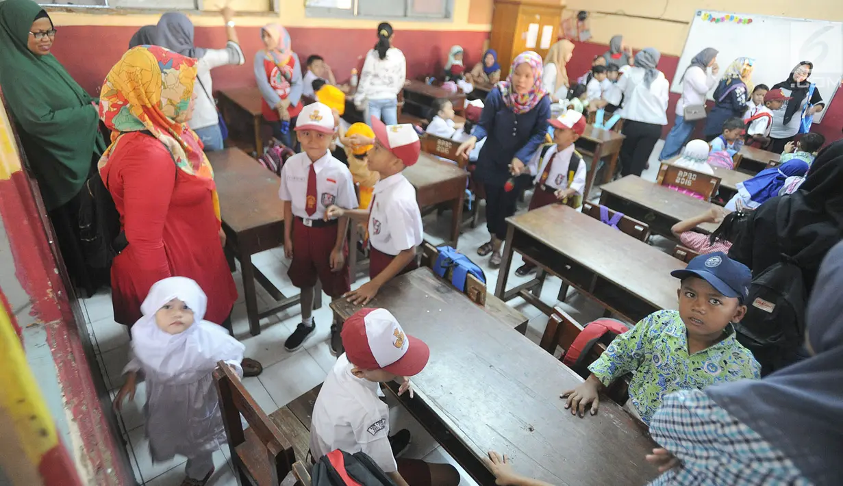Sejumlah orang tua mendampingi putra-putri mereka di hari pertama sekolah di SDN Cinere 1, Depok, Jawa Barat, Senin (15/7/2019). Seluruh siswa SD, SMP dan SMA, pada hari ini mulai masuk sekolah pada tahun ajaran baru 2019/2020. (merdeka.com/Arie Basuki)