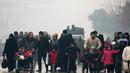 Sejumlah orang melarikan diri dari wilayah yang dikuasai pemberontak, Aleppo, Suriah (13/12). (REUTERS / Abdalrhman Ismail)