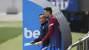 Pelatih interim Barcelona, Sergi Barjuan (kiri) dan Sergio Busquets tiba untuk sesi latihan menjelang lanjutan Liga Spanyol melawan Deportivo Alaves di Barcelona, Kamis (29/10/2021). Latihan pertama Barcelona dipimpin Sergi Barjuan sambil nunggu kedatangan Xavi Hernandez. (Josep LAGO/AFP)