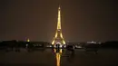 Sejumlah wisatawan menikmati pemandangan Menara Eiffel yang diterangi lampu dari Trocadero Plaza di Paris, Prancis (1/9).( AFP Photo/Ludovic Marin)