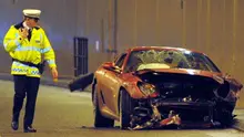 A policeman walks past a crashed ferrari car belonging to Manchester United's Cristiano Ronaldo in a tunnel near Manchester Airport in Manchester, northwest England,/ANDREW YATES 