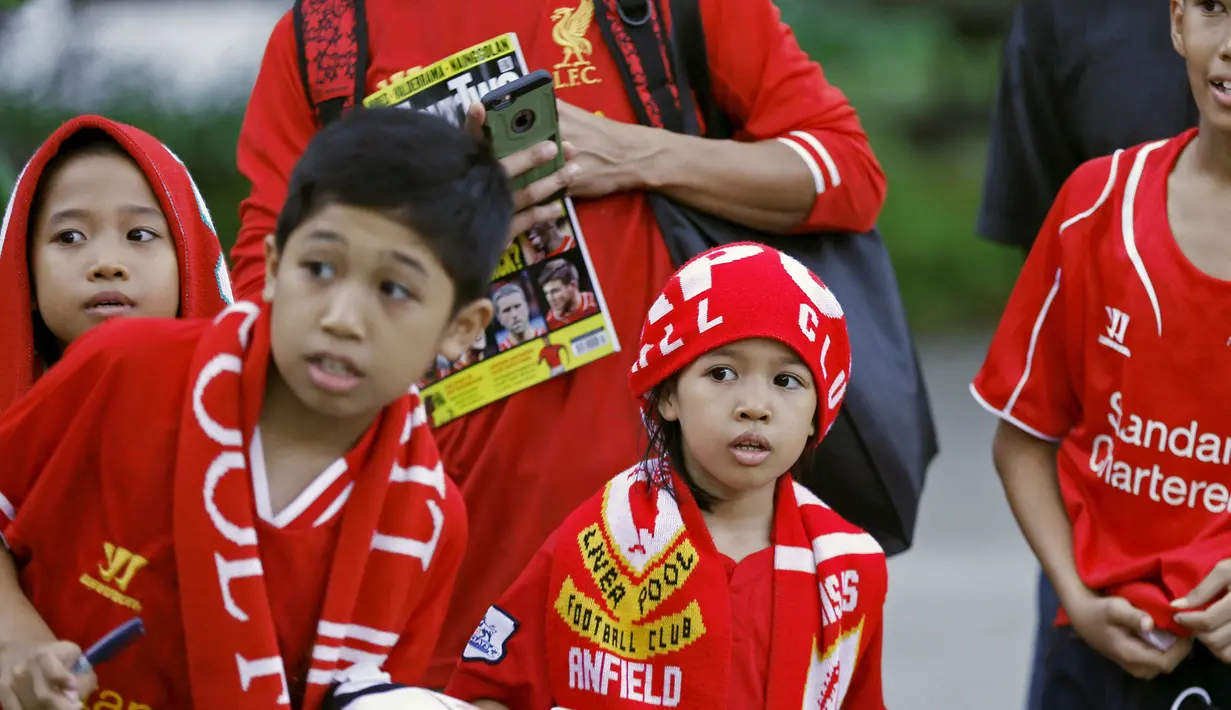 Sejumlah anak penggemar tim Liverpool mengenakan kostum dan atribut Liverpool saat menyambut kedatangan tim kesayangan di Kuala Lumpur, Malaysia, Rabu (22/7/ 2015).  Tim Liverpool akan menggelar jumpa pers di Kuala Lumpur.(REUTERS/Olivia Harris)