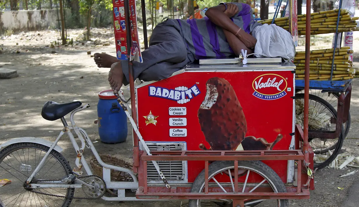 Pedagang es krim tertidur diatas gerobak saat gelombang panas di Allahabad, India, (28/5/2015). Gelombang panas di India telah menewaskan sedikitnya 1.371 karena suhu meningkat di atas 47 Celcius. (REUTERS/Jitendra Prakash)