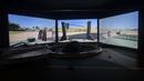 Sebuah simulator untuk kendaraan lapis baja Guarani dipajang untuk pengguna di Pameran Internasional Pertahanan dan Keamanan LAAD 2023.  (AP Photo/Bruna Prado)