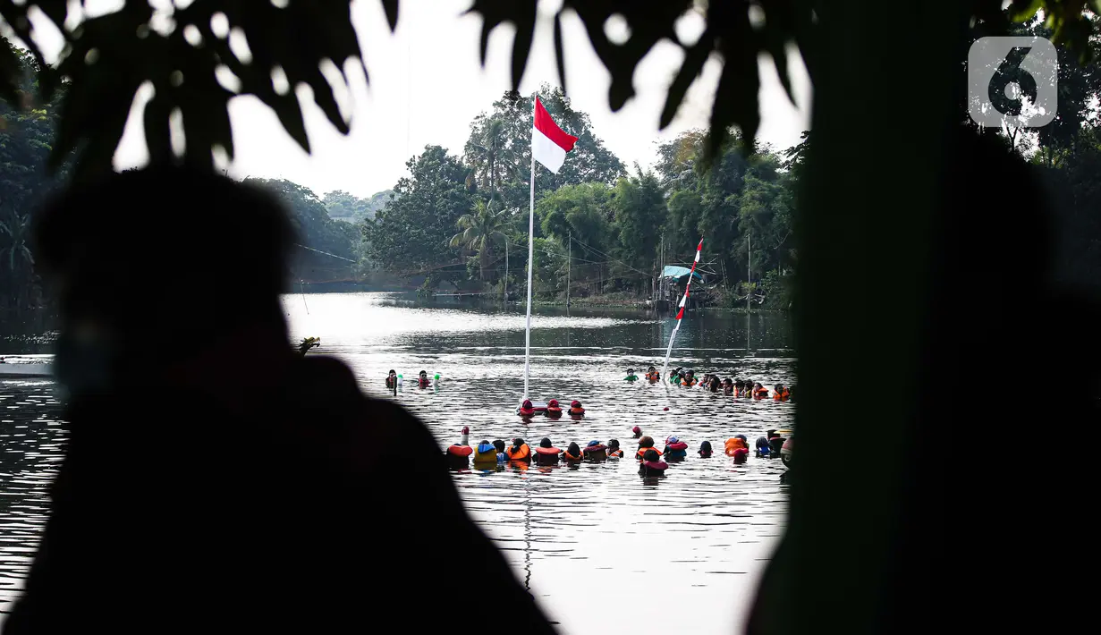 Suasana Upacara Peringatan HUT ke-75 Kemerdekaan RI di Situ Tujuh Muara Pamulang, Tangerang Selatan, Senin (17/8/2020). Upacara yang diikuti ratusan aktivis lingkungan hidup dan juga organisasi kepemudaan itu bertujuan agar pemerintah terus menjaga keberadaan situ. (Liputan6.com/Faizal Fanani)