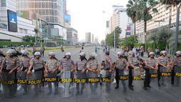 Petugas kepolisian berjaga di kawasan Thamrin, Jakarta, Selasa (21/5). Akibat adanya aksi masa tolak hasil pemilu 2019 membuat sejumlah ruas jalan di kawasan tersebut di tutup. (Liputan6.com/Angga Yuniar)