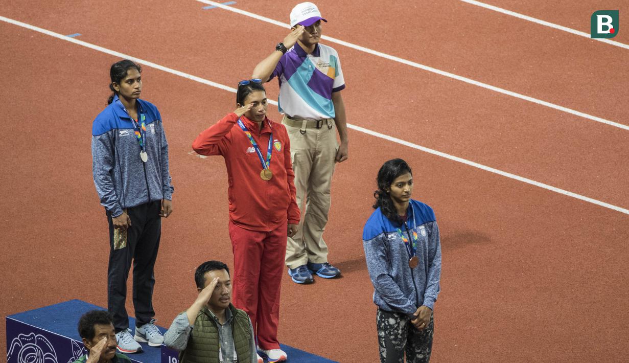 Atlet Indonesia, Maria Londa, hormat usai pengalungan medali pada Invitation Tournament cabang atletik nomor lompat jauh di SUGBK, Jakarta, Minggu (11/2/2018). Dirinya meraih emas dengan lompatan terjauh 6,43 meter. (Bola.com/Vitalis Yogi Trisna)