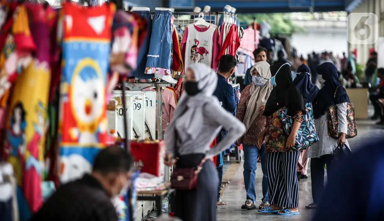 Sejumlah calon pembeli melihat-lihat pakaian yang dijual di Jembatan Penyeberangan Multiguna atau Skybridge Tanah Abang, Jakarta, Jumat (19/6/2020). Kendati pusat perbelanjaan telah dibuka sejak 15 Juli 2020, aktivitas jual beli di Skybridge Tanah Abang terpantau sepi. (Liputan6.com/Faizal Fanani)