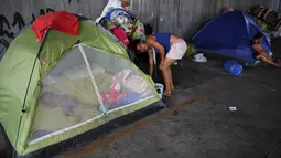 Seorang anak tertidur disebuah tenda yang berada dibawah jembatan, Sao Paulo, Brasil, (18/12). Mereka adalah keluargatidak mampu yang tidak memiliki rumah. (REUTERS/Nacho Doce)