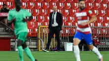 Pelatih Real Madrid, Zinedine Zidane (tengah) melihat pemainnya bertanding melawan Granada pada pertandingan lanjutan La Liga Spanyol  di stadion Nuevo Los Carmenes di Granada (13/7/2020). Madrid menang tipis 2-1 atas Granada. (AFP/Jorge Guerrero)