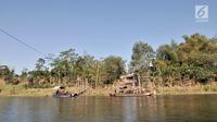 Pemandangan saat warga menaiki perahu eretan atau tambangan menyeberangi Sungai Brantas, Desa Mayan, Mojo, Kediri, Sabtu (29/9). Perahu eretan biasanya mengangkut petani, siswa, hingga pengendara sepeda motor. (Merdeka.com/Iqbal Nugroho)