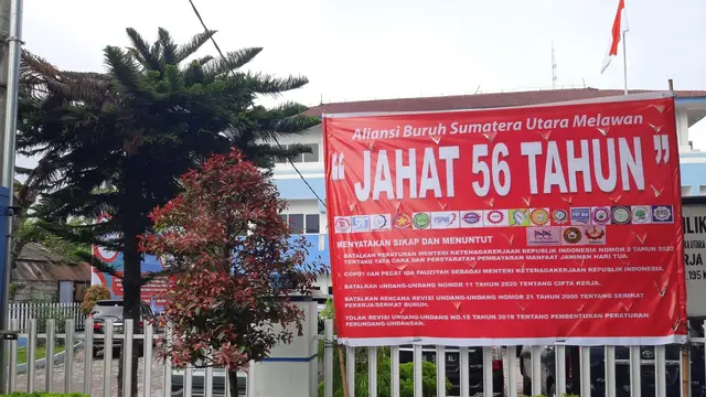 Baliho bertuliskan "Menolak JAHAT 56 Tahun"