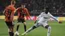 <p>Penyerang Real Madrid, Vinicius Junior berusaha menghalau bola umpan pemain Shakhtar Donetsk, Yukhym Konoplya pada pertandingan lanjutan grup F Liga Champions di stadion Polish Army Stadium di Warsawa, Polandia, Rabu, 12 Oktober 2022. Shakhtar Donetsk bermain imbang atas Real Madrid 1-1. (AP Photo/Michal Dyjuk )</p>