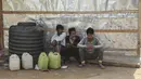 Pengungsi Rohingya duduk di luar kamp sementara mereka di pinggiran Jammu, India, 7 Maret 2021. Pihak berwenang di Kashmir yang dikuasai India telah mengirim setidaknya 168 pengungsi Rohingya ke pusat penampungan untuk mendeportasi ribuan pengungsi yang tinggal di wilayah itu (AP Photo/Channi Anand)