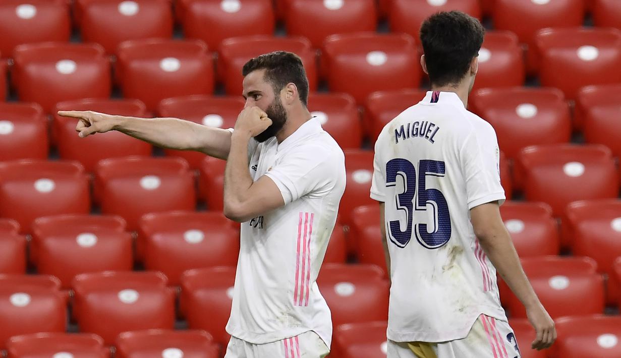 Pemain Real Madrid, Nacho Fernandez, melakukan selebrasi usai mencetak gol ke gawang Athletic Bilbao pada laga Liga Spanyol di Stadion San Mames, Minggu (16/5/2021). Real Madrid menang dengan skor 1-0. (AFP/Ander Gillenea)