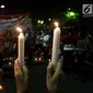 Masyarakat yang tergabung dalam Silent Majority Forum melakukan aksi damai dengan menyalakan lilin di Silang Monas, Jakarta, Kamis (1/6). Mereka mengutuk dengan keras segala bentuk intoleransi, radikalisme, terorisme, dan intimidasi.(Liputan6/JohanTallo)