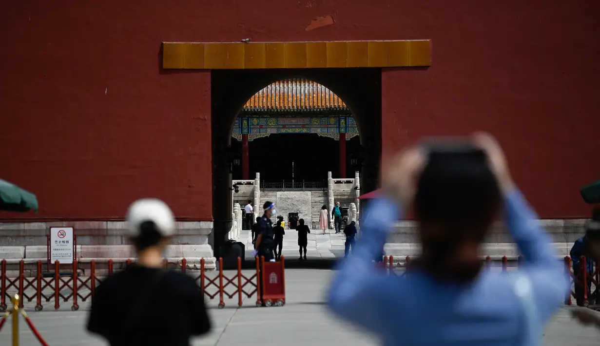 Orang-orang mengunjungi Kota Terlarang di Beijing sebelum kunjungan mereka setelah pemerintah melonggarkan beberapa pembatasan Covid-19, Selasa (7/6/2022). Pengunjung mulai kembali ke restoran di sebagian besar wilayah Beijing untuk pertama kalinya dalam lebih dari sebulan pada Senin, 6 Juni 2022. (WANG Zhao / AFP)