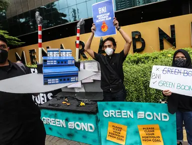 Aktivis yang tergabung dalam kampanye #bersihkanbankmu menggelar aksi di depan kantor Bank Tabungan Negara (BNI), Jakarta, Jumat (17/6/2022). Dalam aksinya mereka mempertanyakan keseriusan Bank BI dalam penghentian pembiayaan proyek batu bara dan menyerukan untuk menghentikan praktek Greenwashing. (Liputan6.com/Johan Tallo)
