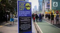 “Jakarta Car Free Day Bukan Tempat Kampanye Politik” bunyi tulisan di poster dengan latar belakang berwarna biru itu. (Liputan6.com/Angga Yuniar)