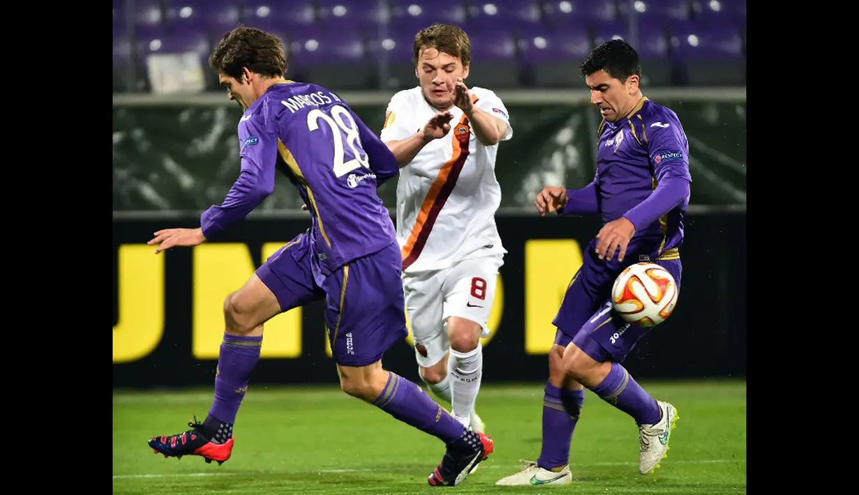 Gelandang AS Roma, Adem Ljajic berusaha melewati dua pemain Fiorentina di leg pertama  16 besar Liga Europa di Stadion Artemio Franchi, Italia, Jumat (13/3/2015) . Fiorentina bermain imbang 1-1 dengan AS Roma. (AFP PHOTO/Gabriel Bouys)