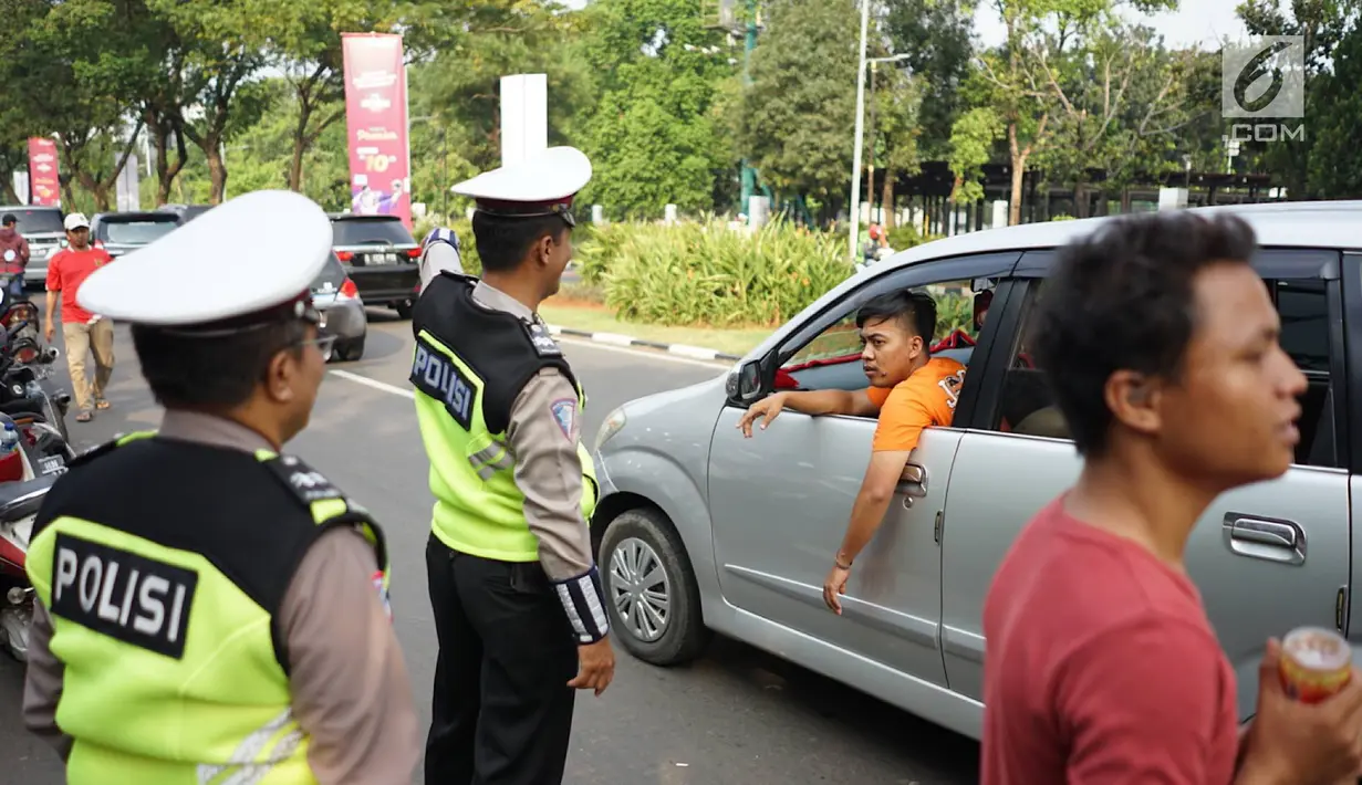 Petugas kepolisian mengatur arus lalu lintas kendaraan di sekitar SUGBK Senayan, Jakarta, Rabu (10/7/2019). Banyaknya kendaraan suporter Persija yang ingin menonton pertandingan membuat sejumlah arus lalu lintas dialihkan untuk mengurai kemacetan. (Liputan6.com/Immanuel Antonius)
