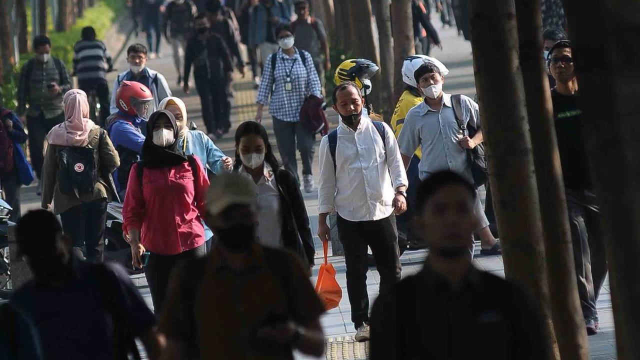 Aktivitas para pekerja saat berjalan menuju kantor mereka masing-masing di tengah kualitas udara yang tidak sehat di sepanjang Jalan Kawasan Sudirman-Thamrin, Jakarta, Senin (14/8/2023).