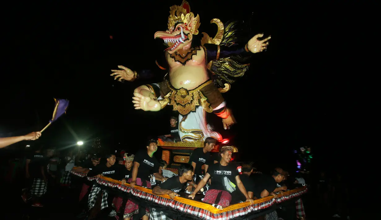 Sejumlah pemuda mengarak Ogoh-Ogoh atau boneka raksasa menjelang Hari Raya Nyepi Tahun Saka 1940 di Bali, Kamis (15/3). Parade Ogoh-Ogoh itu bertujuan agar Hari Raya Nyepi dapat dilaksanakan dengan penuh keheningan dan kedamaian. (AP/Firdia Lisnawati)